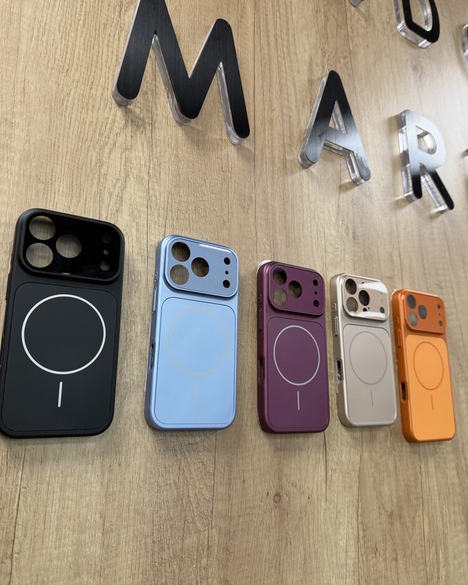 Five colourful MagSafe cases on the wooden wall with the Lido Market letters
